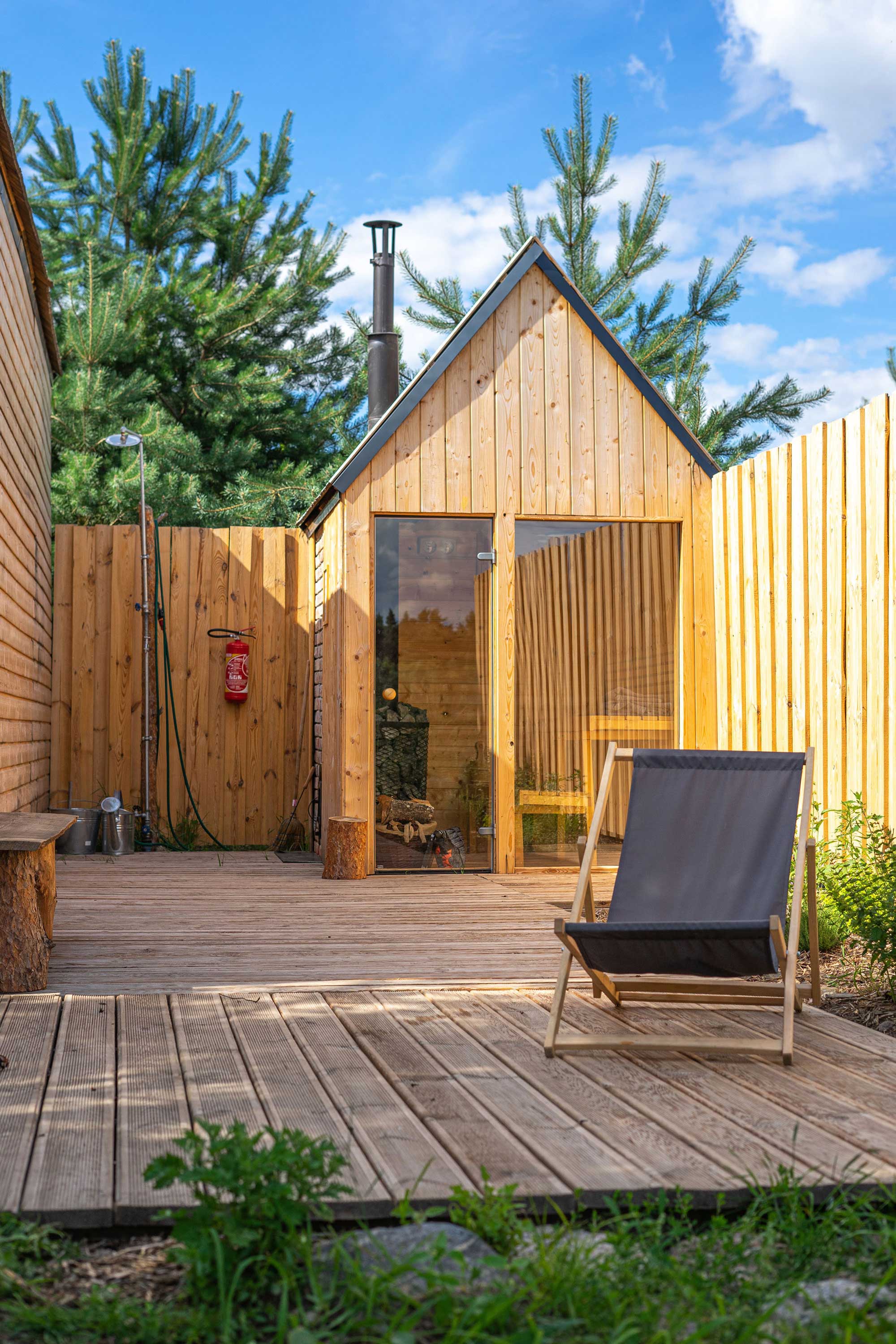 An outdoor wood-fired finish sauna. Garden shower and a sunbed.